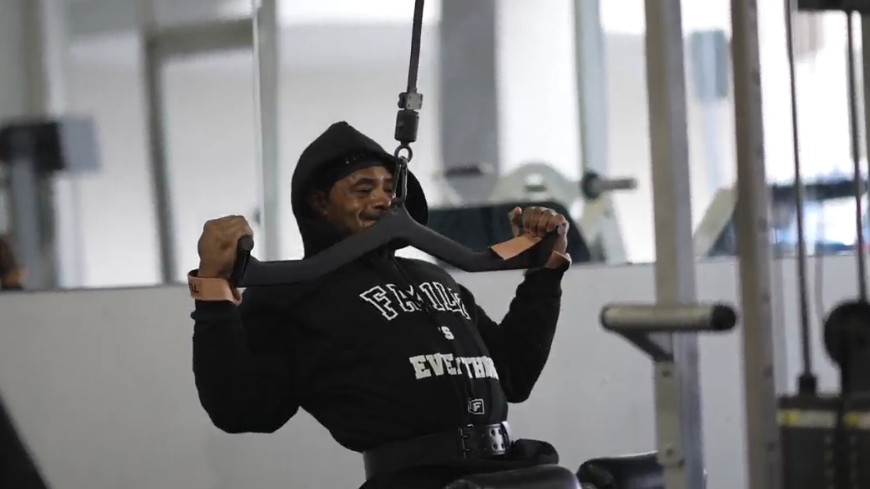 man doing lat pulldowns with lifting straps