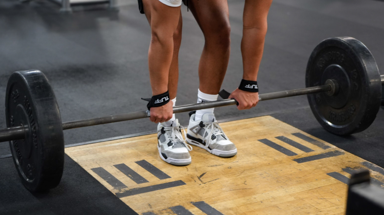 muscular man preparing to do romanian deadlift
