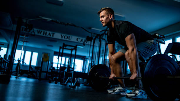 trainer preparing to do stiff leg deadlift