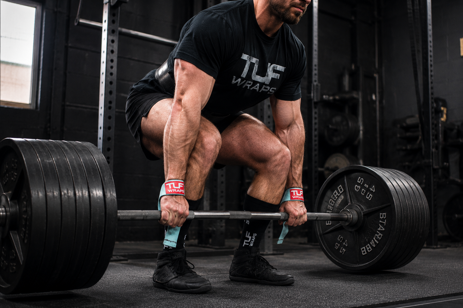 Lifter using a hook grip on a loaded barbell for a heavy deadlift
