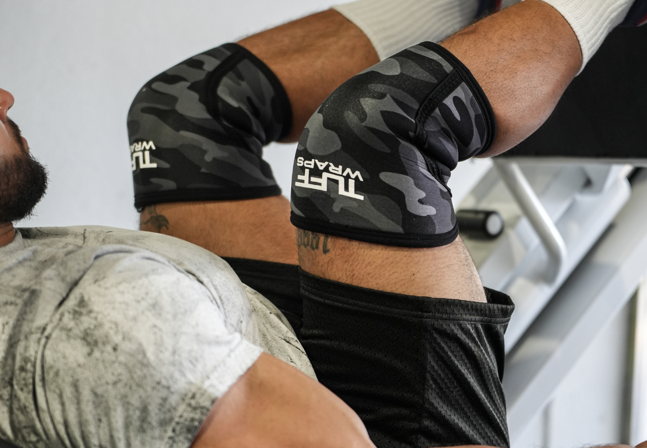 man using knee wraps for leg press